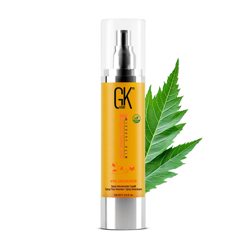 GK Hair VolumizeHer Spray Pro 100 ml amber pump bottle with clear cap, front view beside a green leaf