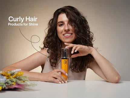 A Woman Smiling and Holding a CurlsDefineHer