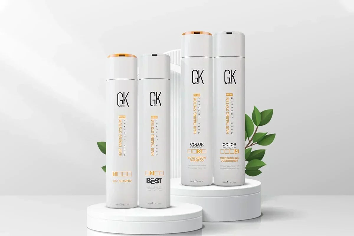 GK Hair's The Best Keratin Professional Hair Kit displayed on white podiums, including pH+ Shampoo, The Best Keratin Treatment, Moisturizing Shampoo, and Moisturizing Conditioner