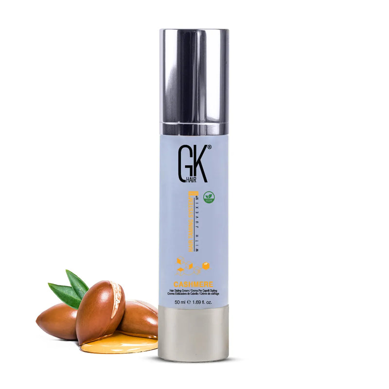 GK Hair Cashmere Hair Styling Cream 50 ml lilac pump bottle with argan nuts and a pool of oil on white