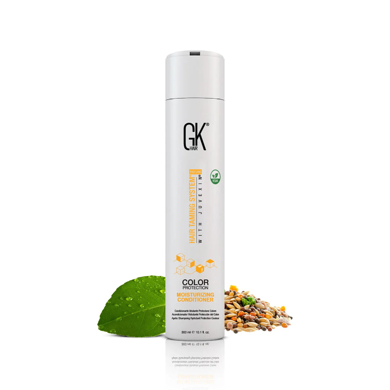 GK Hair Moisturizing Conditioner 300 ml Color Protection bottle beside a green leaf and mixed seeds on white